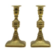 A pair of George III Golden Jubilee brass ejector candlesticks