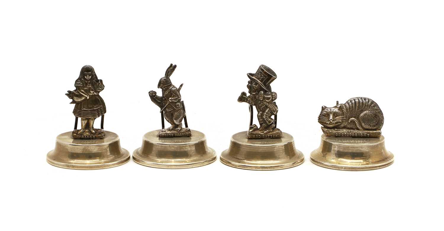 A set of four silver novelty menu holders