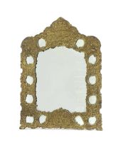 A gilt repoussé metal mirror