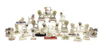 A collection of Staffordshire pottery poodles,
