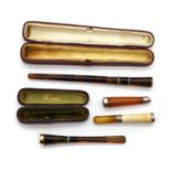 Two tortoiseshell and diamond inlaid cigarette holders,