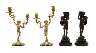 A pair of brass figural candlesticks