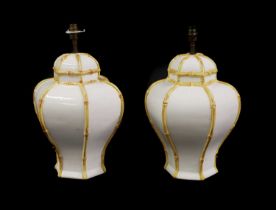 A pair of white-glazed pottery lamps