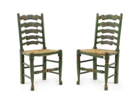 A pair of painted ladderback chairs