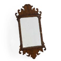 A George II walnut fret carved wall mirror,