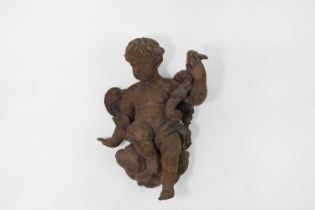 A baroque carved and painted pine putto,