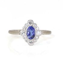 A white gold synthetic sapphire and diamond cluster ring,