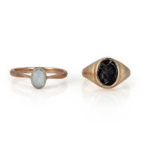 A 9ct gold onyx ring and an opal ring,