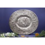 A chased white metal oval dish,