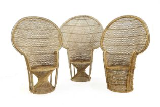 A group of three cane peacock chairs