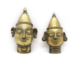 A pair of brass Siva masks,