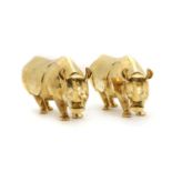 A pair of gilt porcelain rhinoceros