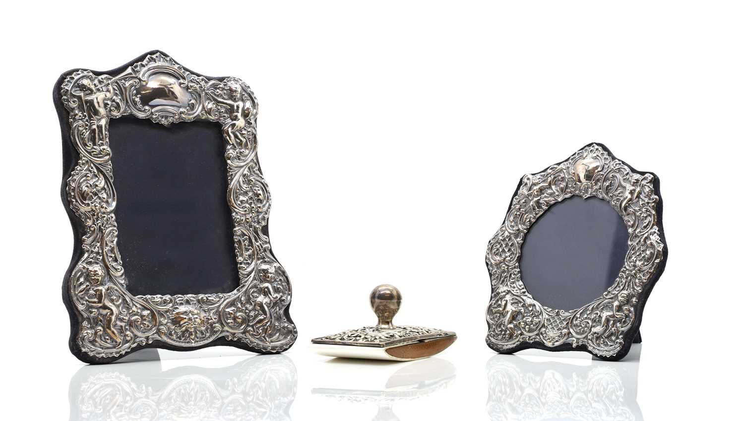 Two silver easel back photograph frames,