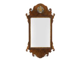 A George III style walnut and parcel gilt fret carved mirror,