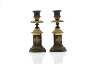 A pair of Regency bronze and ormolu candlesticks,