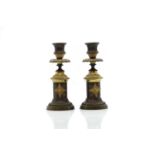 A pair of Regency bronze and ormolu candlesticks,