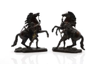 A pair of patinated bronze sculptures,