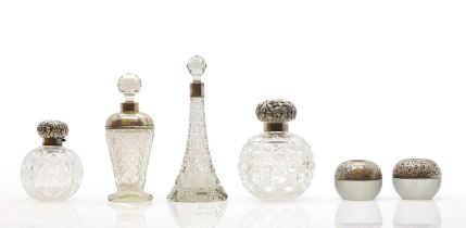 A collection of silver mounted glass scent bottles,