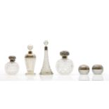 A collection of silver mounted glass scent bottles,