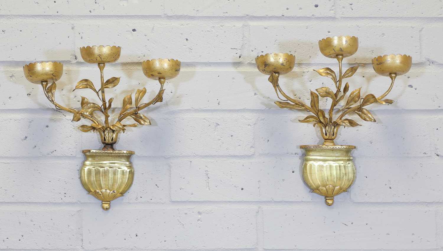 A pair of gold-painted three-branch wall lights,