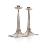 A pair of Arts and Crafts silver candlesticks,