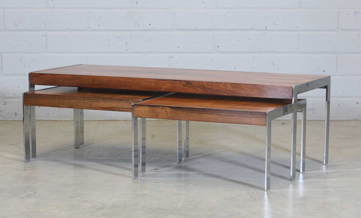 § A Merrow Associates rosewood and chrome nest of tables,