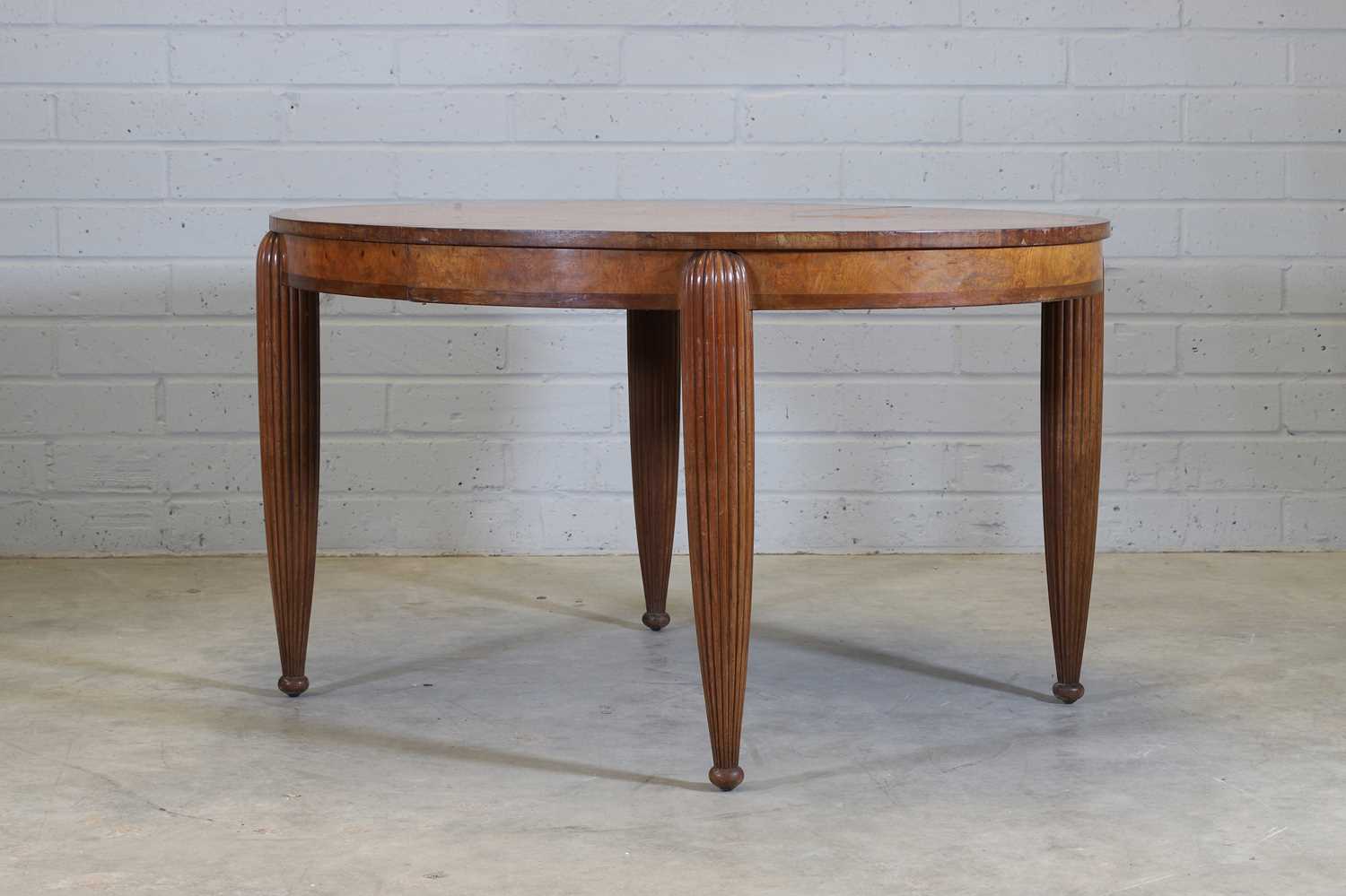A French Art Deco walnut and mahogany dining table,
