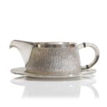 ▲ A textured sterling silver cream jug,
