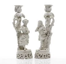 A pair of Dresden 'blanc de chine' figural candlesticks,