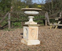 A large painted cast iron urn and stand