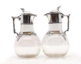 A pair of Victorian silver mounted glass claret jugs