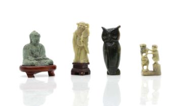 A collection of carved soapstone figures,