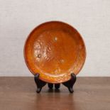 A Chinese amber-glazed saucer,