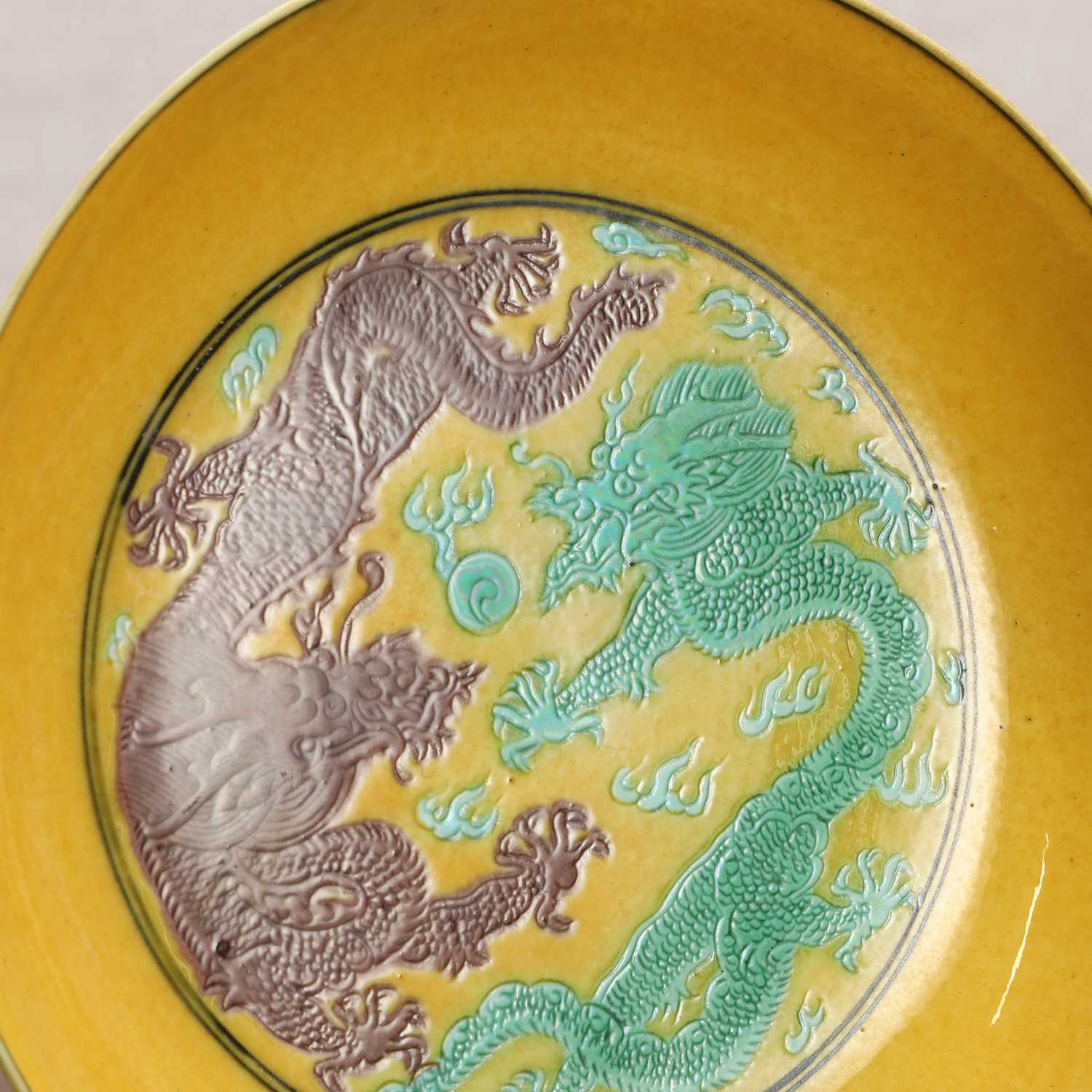 A Chinese porcelain yellow-ground saucer dish, - Image 4 of 4