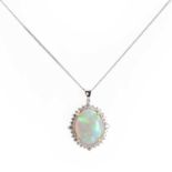 An oval cabochon opal and diamond cluster pendant,