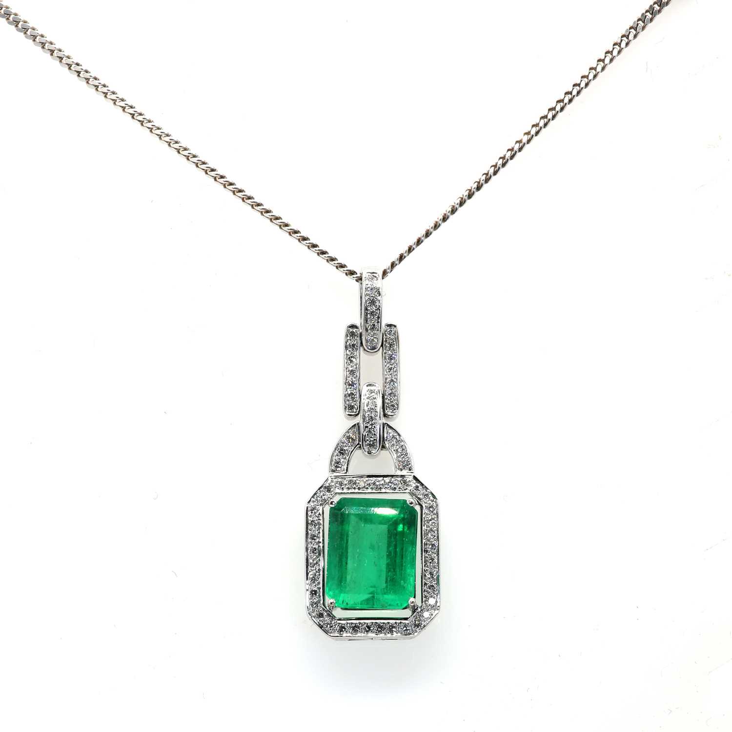 An 18ct white gold Colombian emerald and diamond pendant and chain,