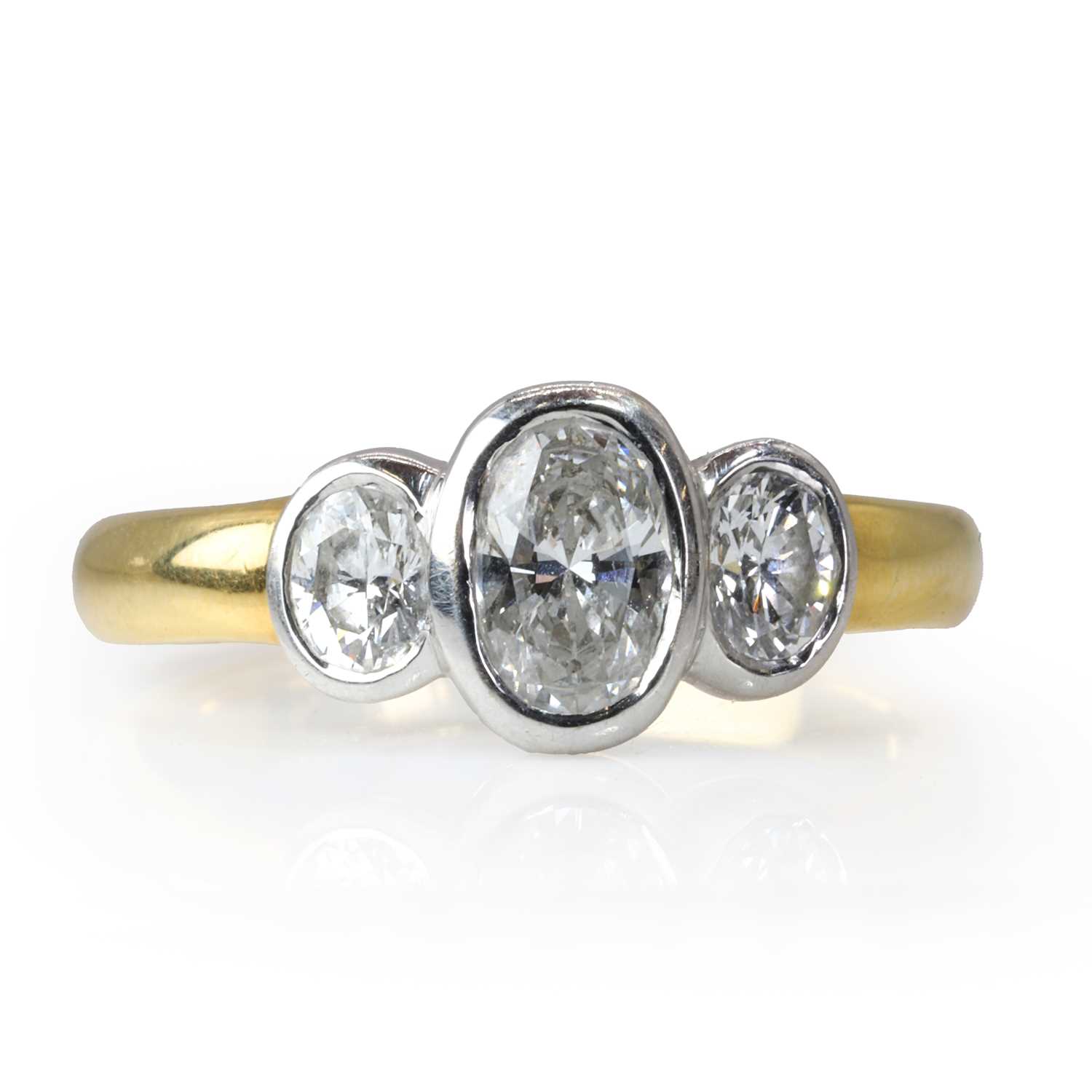 An 18ct gold and oval cut diamond three stone ring,