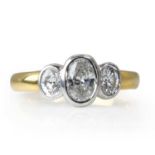An 18ct gold and oval cut diamond three stone ring,