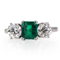 An emerald and diamond three stone ring,