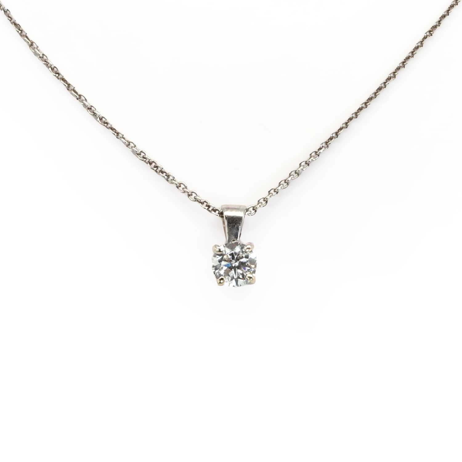 An 18ct white gold single stone diamond pendant and chain,