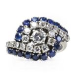 A white gold sapphire and diamond crossover ring,