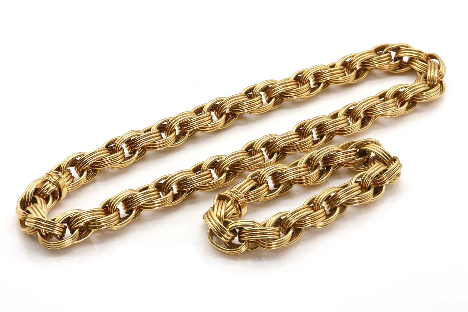 A gold oval link necklace and bracelet suite, by Tiffany & Co.,