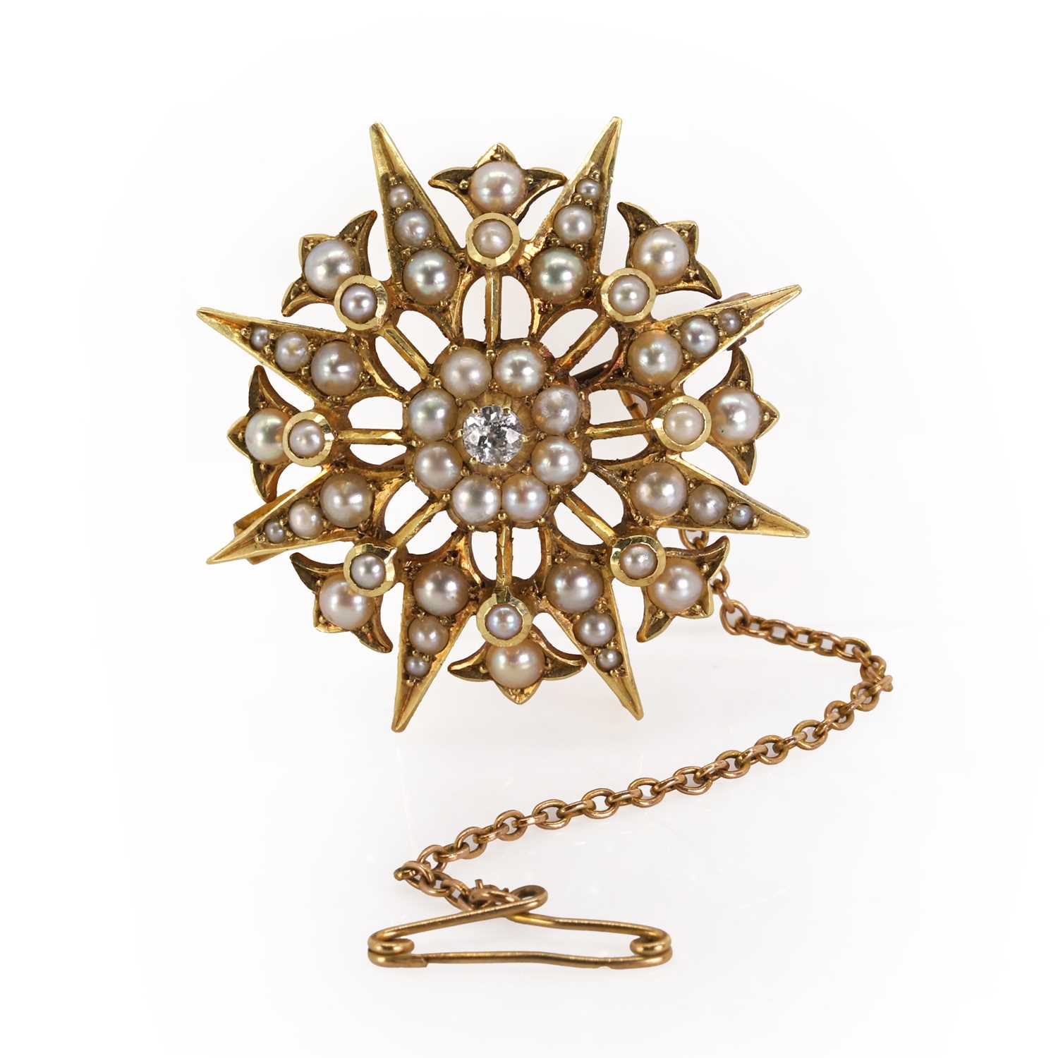 An Edwardian seed pearl and diamond starburst brooch/pendant,