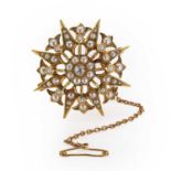 An Edwardian seed pearl and diamond starburst brooch/pendant,