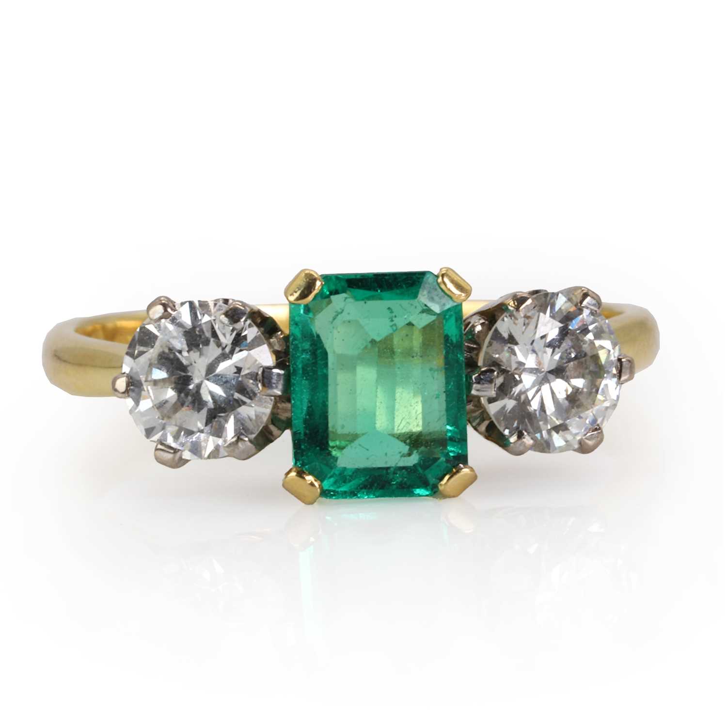 An 18ct gold Colombian emerald and diamond three stone ring,