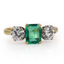 An 18ct gold Colombian emerald and diamond three stone ring,