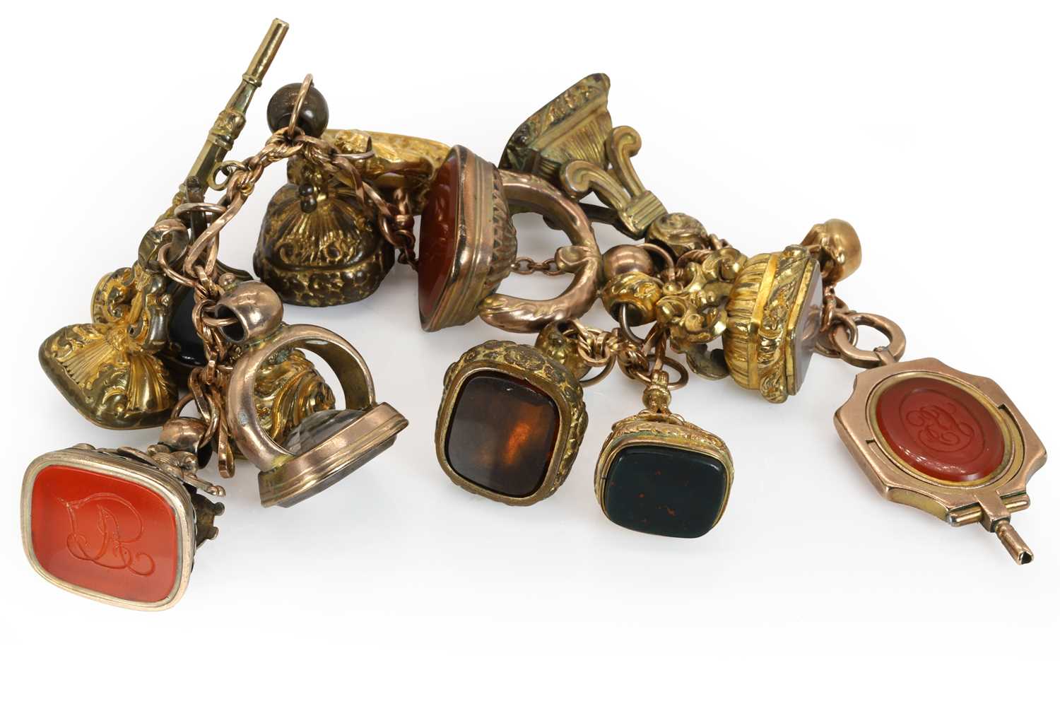 A rose gold bracelet suspending assorted fob seals and watch keys,