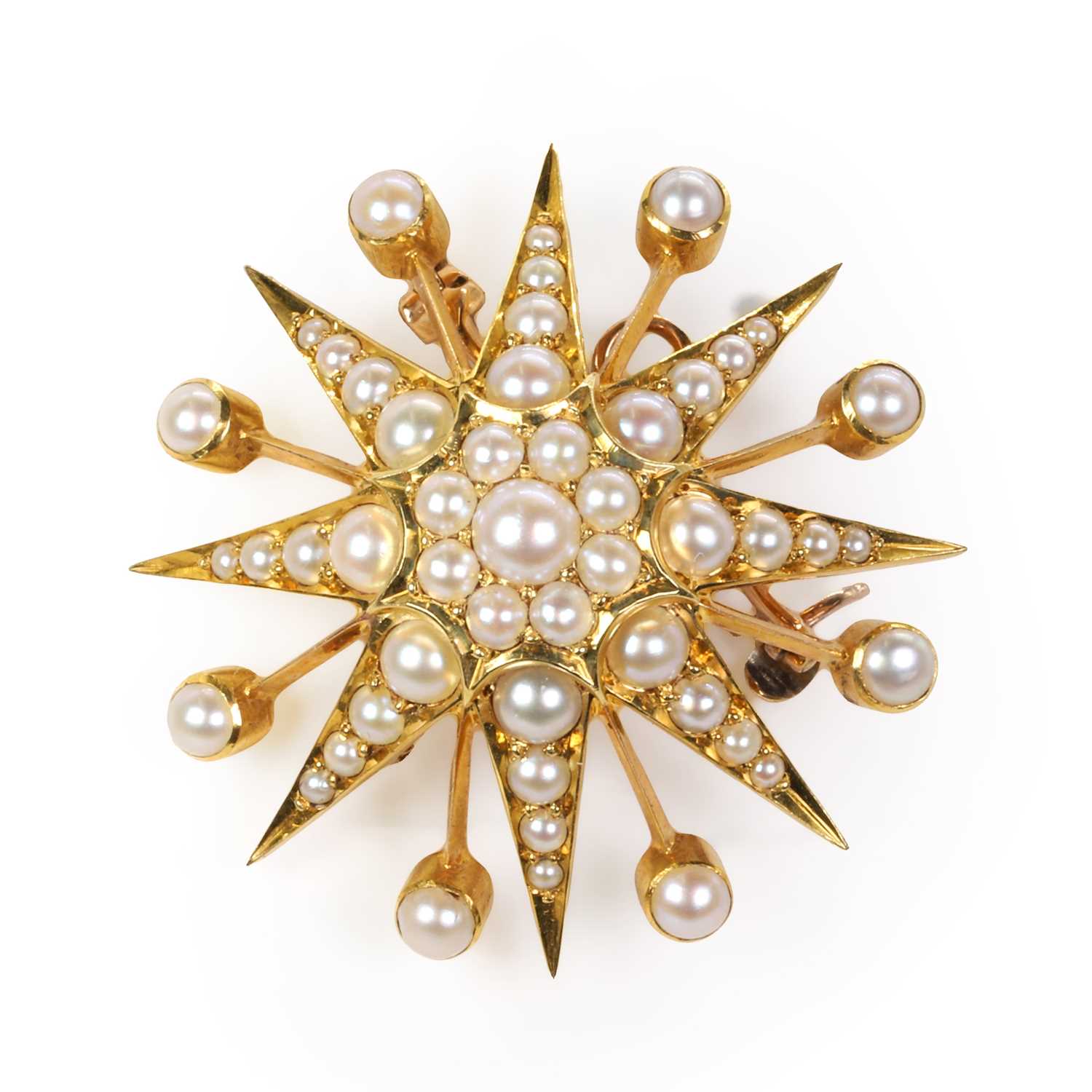 An Edwardian gold and pearl starburst brooch,