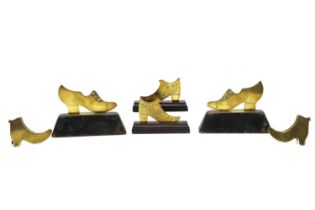 Three pairs of brass shoe chimney adornments,