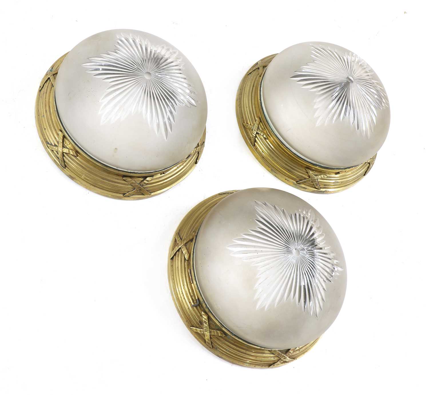 A set of three gilt-metal and frosted glass ceiling lights.